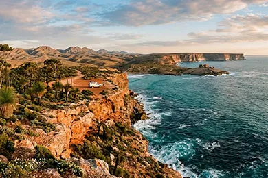 Beautiful coastal landscape with rugged cliffs, crashing waves, and a distant headland during golden hour in south australia