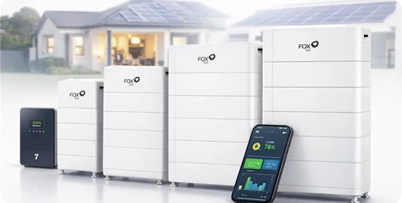 Four white FOX ESS units of increasing size, a smartphone showing energy graphs, and a blurred solar home in the background.